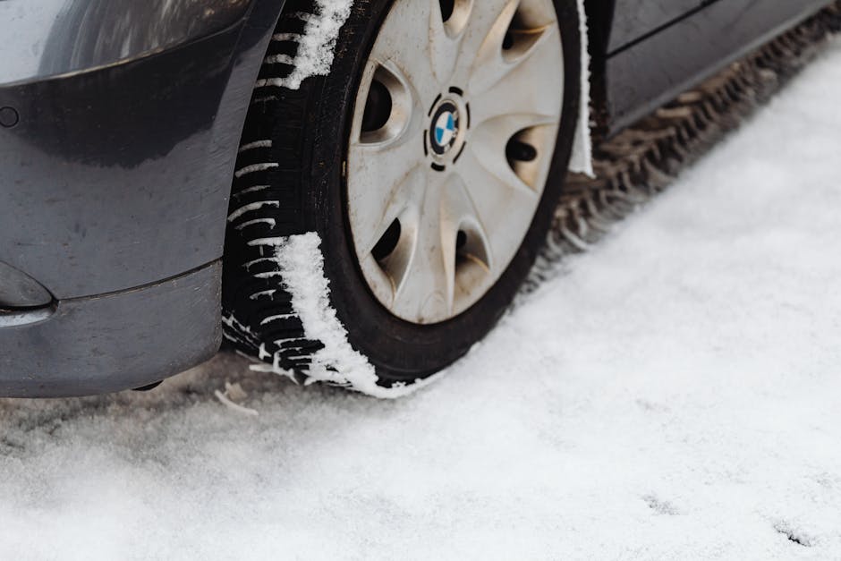 Auto technician carefully checking tire tread depth and alignment