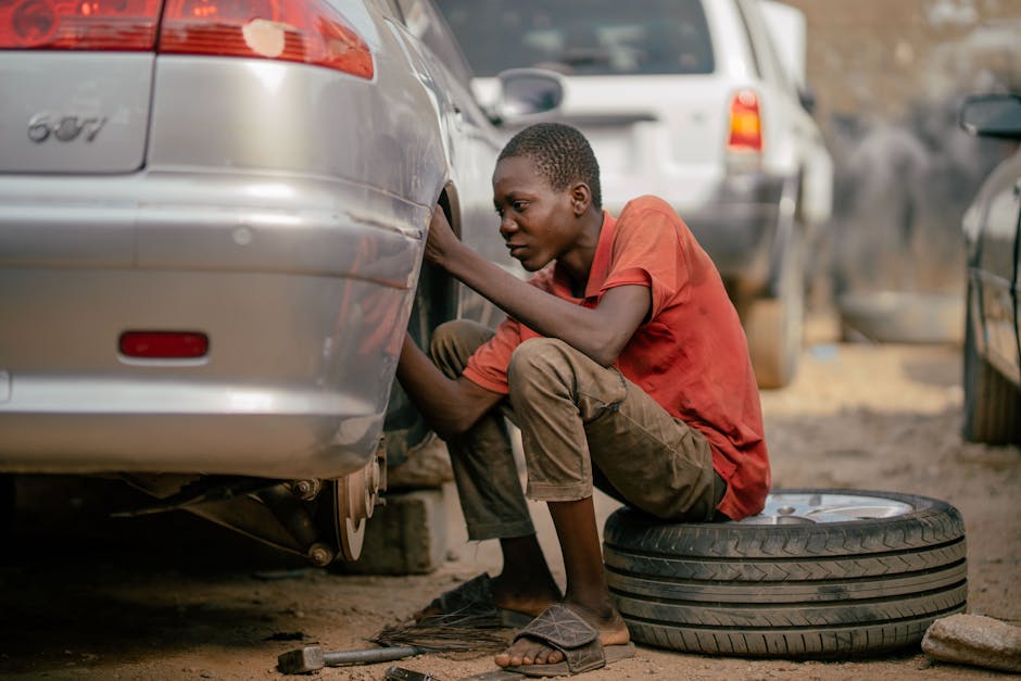 Mechanic actively changing a car tire in a professional garage